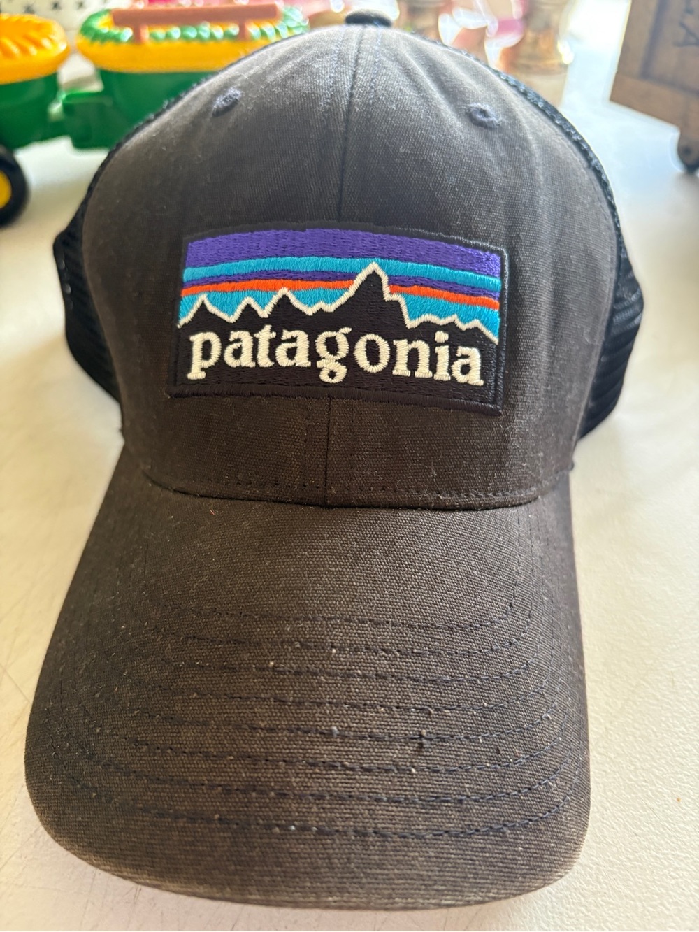 Patagonia  Black Trucker Hat with Blue, Purple, Teal and Orange Logo